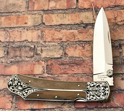 Harvey McBurnette Eagle Nest Mastodon Engraved Lockback