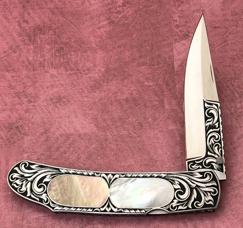 Harvey McBurnette Eagle Nest Engraved Pearl Lockback