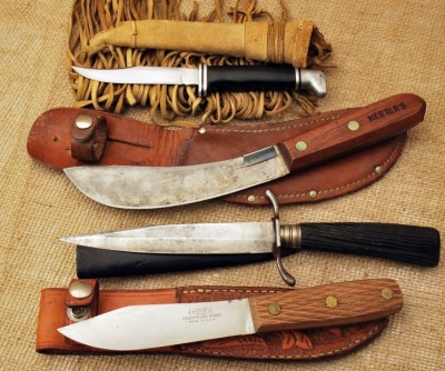 Four outdoor knives: Buck 102, Herters, German trench knife, Russell green river