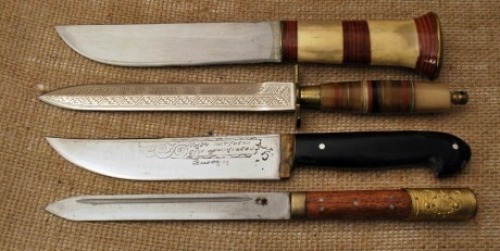 Four imported knives, pukko with bone and stacked leather washers, dagger with etched blade and brass fitting, Hunter with etched blade and horn handle in a foreign language I do not know, and Oriental motif straight blade with wood handles and brass pomm