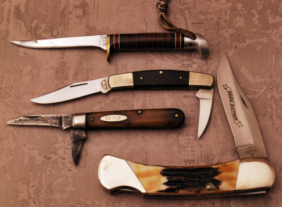 Group of Three folders and one fixed blade