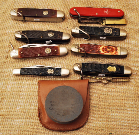 Nine Official Boy Scout knives & Stone