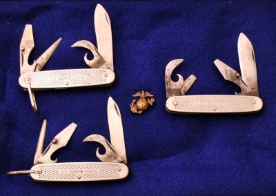 Trio of U.S. Marine Corps Metal Utility Knives, and Eagle, Globe and Ancor Lapel Pin