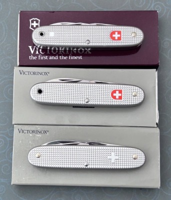 Three Victorinox Swiss Army Knives