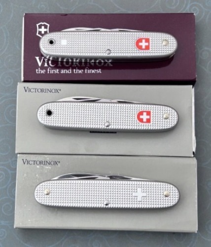 Three Victorinox Swiss Army Knives