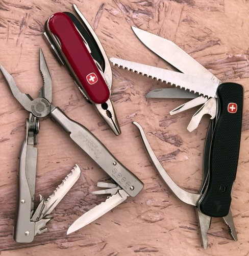 Two Wenger and a Buck Multitools