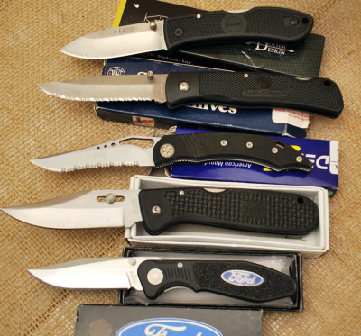 Five Imported black handled knives