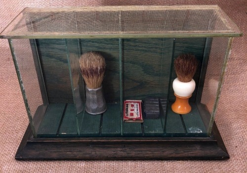 Glass Display with Two Shave Brushes, Cattaraugus razor blades and Cattaraugus Metal stamp