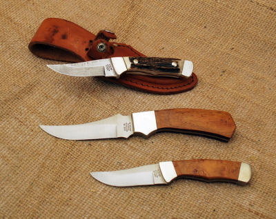 Case Trio, one Damascus blade, two with wood handles.